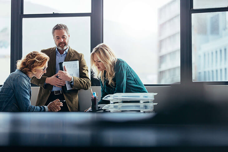 Three Office Workers Discussing the impact of the Confidence Gap